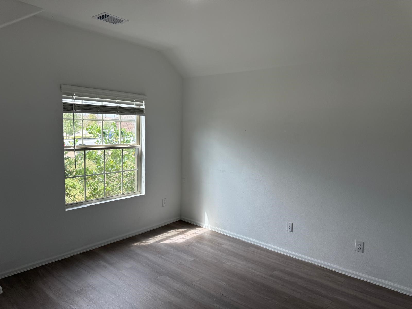 5335 Winding Strm Drive Rosenberg, TX 77469 - Photo 16 of 26 an empty room with wooden floor and windows