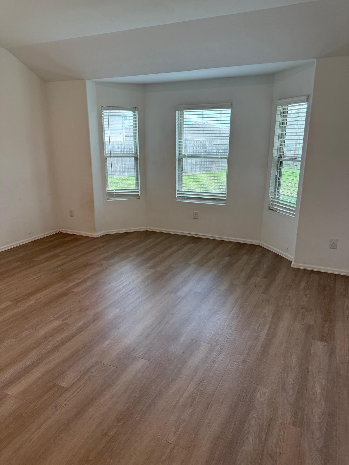 5335 Winding Strm Drive Rosenberg, TX 77469 - Photo 7 of 26 an empty room with wooden floor and windows