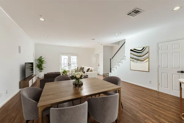 a view of a dining room with furniture and wooden floor
