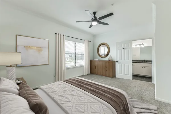 a bedroom with a large bed and a chandelier