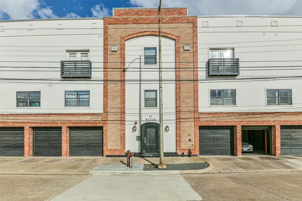 a view of a brick house with many windows