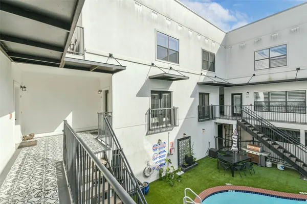 a view of a house with pool and chairs