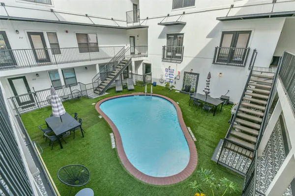an aerial view of a house with swimming pool and furniture