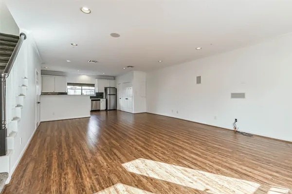 a view of a kitchen with a sink and wooden floor