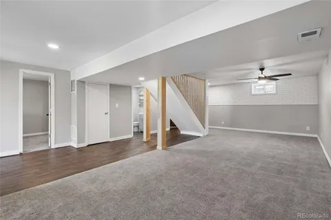 an empty room with staircase and white walls