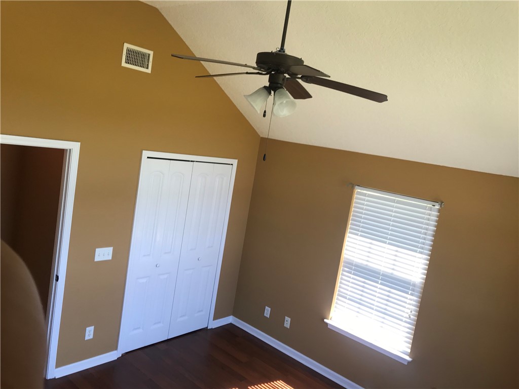 128 Avondale Road Brunswick, GA 31523 - Photo 10 of 12 BEDROOM 1 - VAULTED CEILINGS | LARGE CLOSETS | NATURAL LIGHT | VINYL WOOD FLOORING