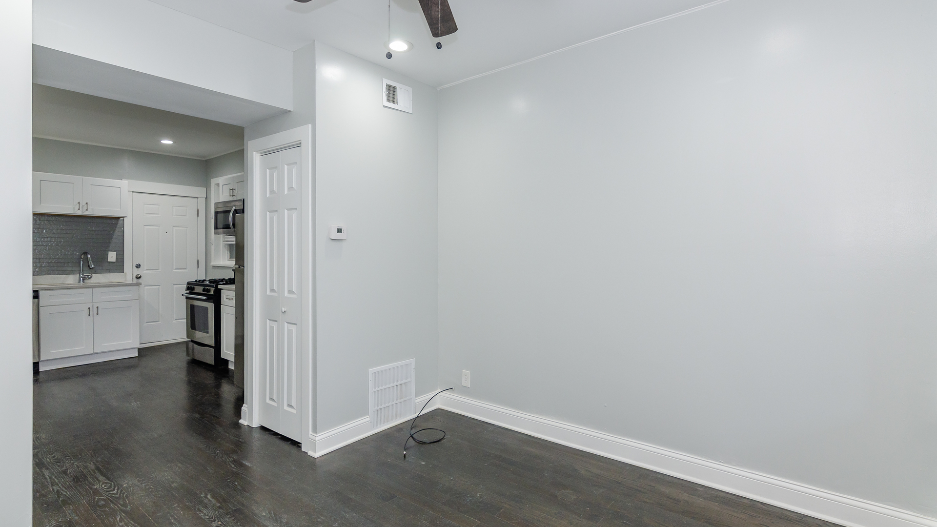 2049 West Coulter Street, Unit 1R Chicago, IL 60608 - Photo 2 of 10 a view of a kitchen with white cabinets and wooden floor