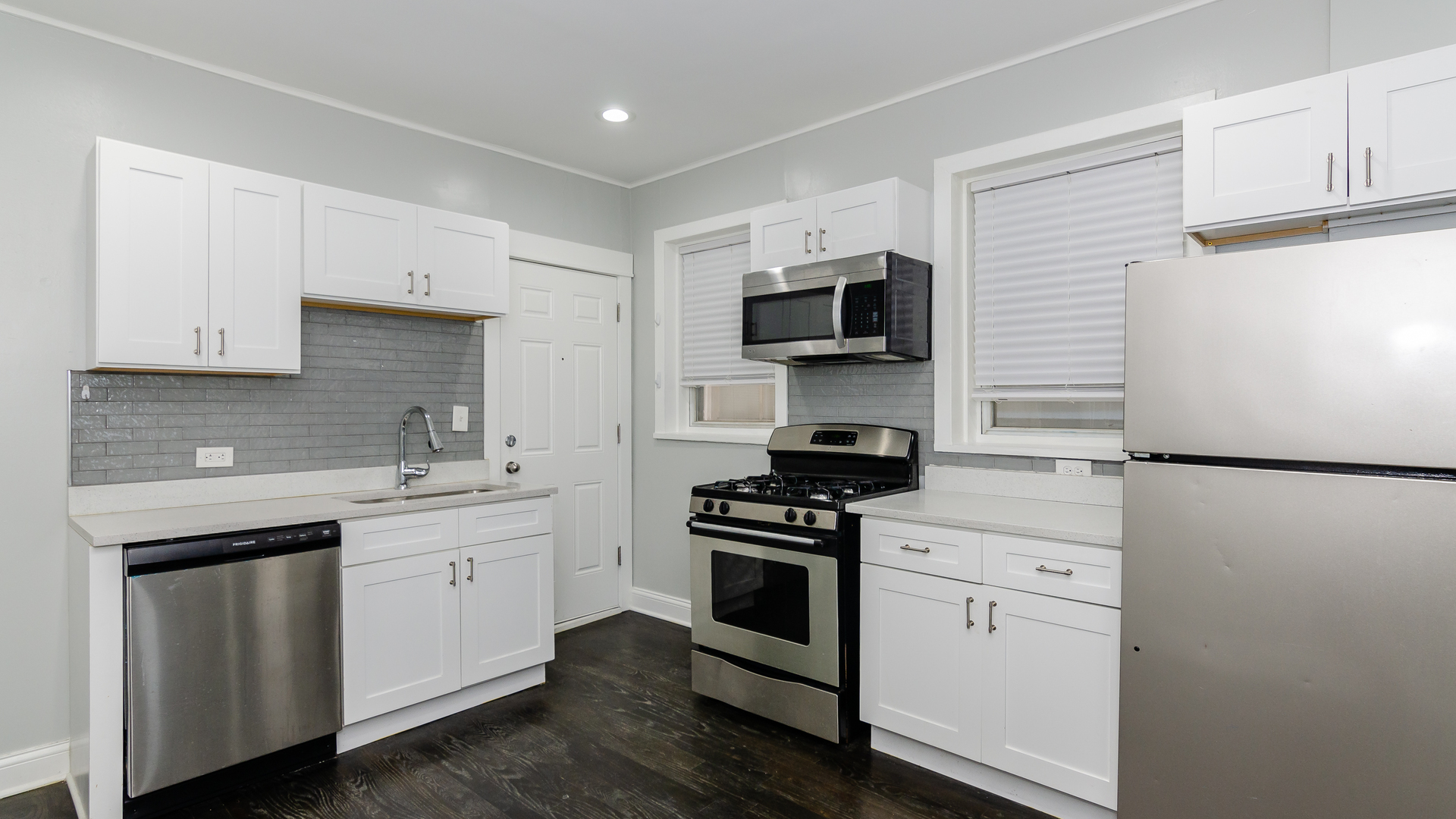 2049 West Coulter Street, Unit 1R Chicago, IL 60608 - Photo 5 of 10 a kitchen with stainless steel appliances a sink cabinets and a refrigerator