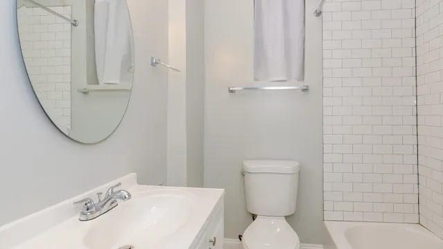 a white toilet sitting next to a bathroom sink