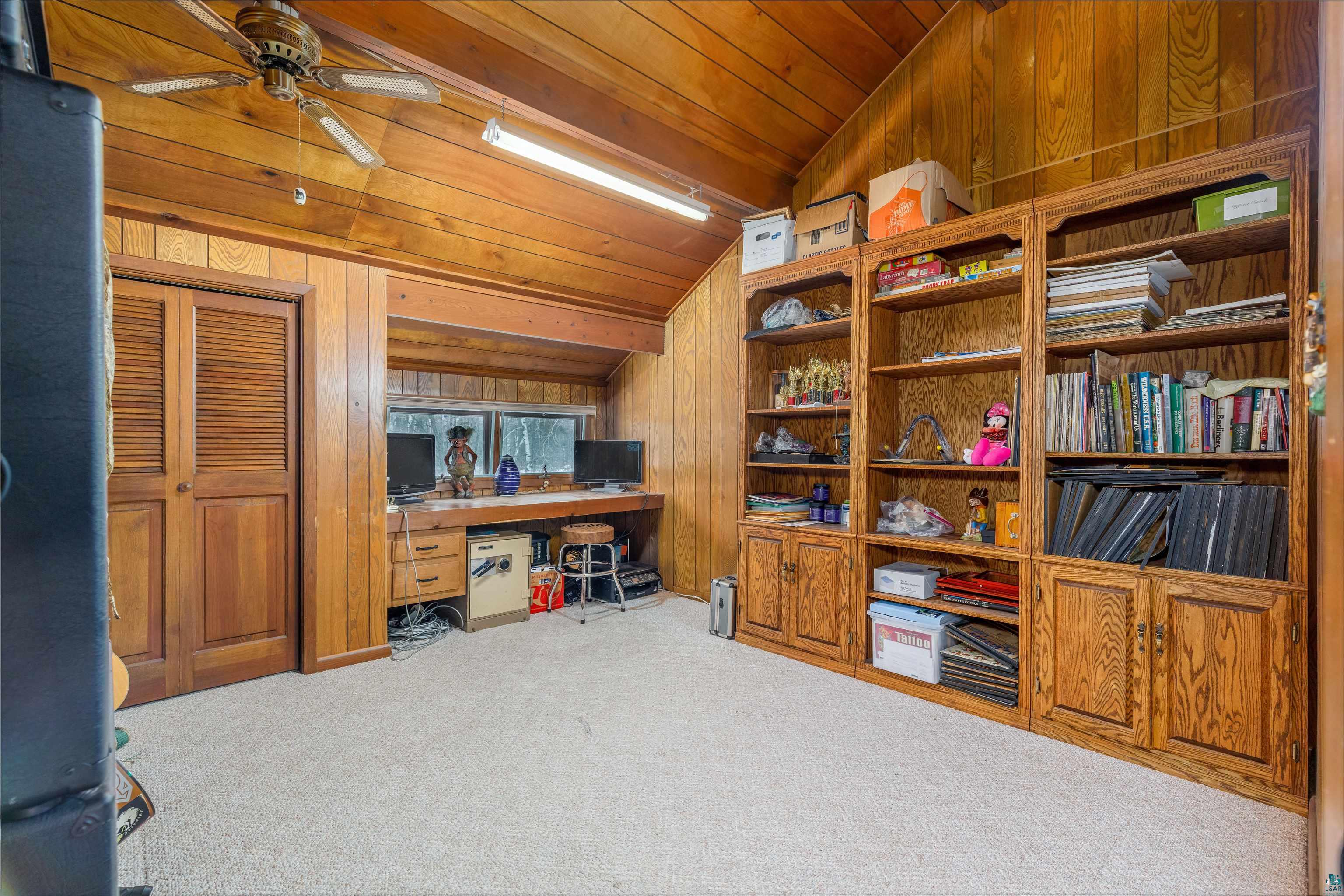 2641 Priest Point Road Ely, MN 55731 - Photo 14 of 38 Office space featuring wooden walls, carpet floors, a ceiling fan, and a vaulted wooden ceiling