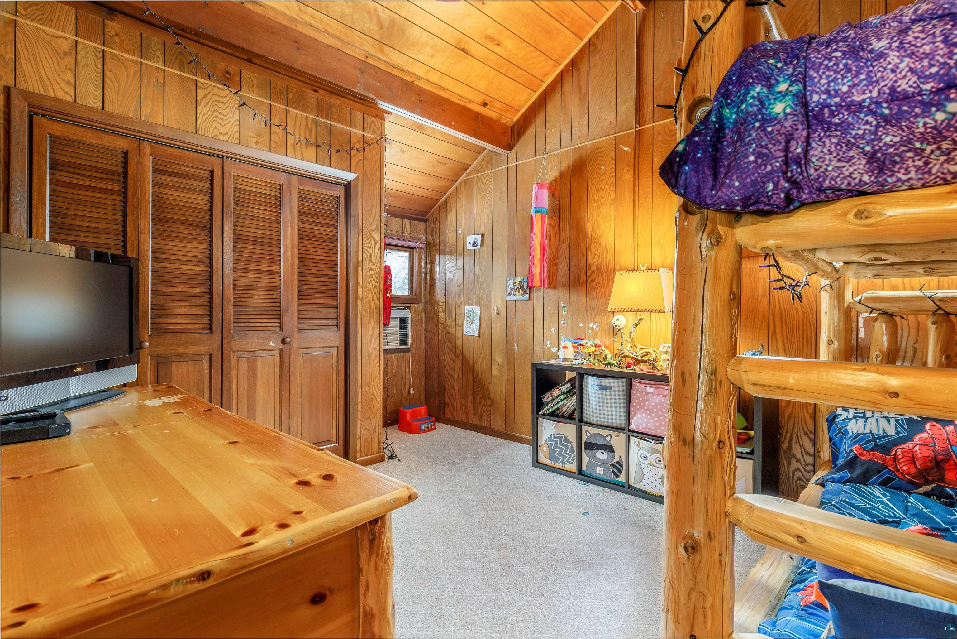 2641 Priest Point Road Ely, MN 55731 - Photo 23 of 38 Office space with light colored carpet, wood walls, lofted ceiling with beams, and wood ceiling