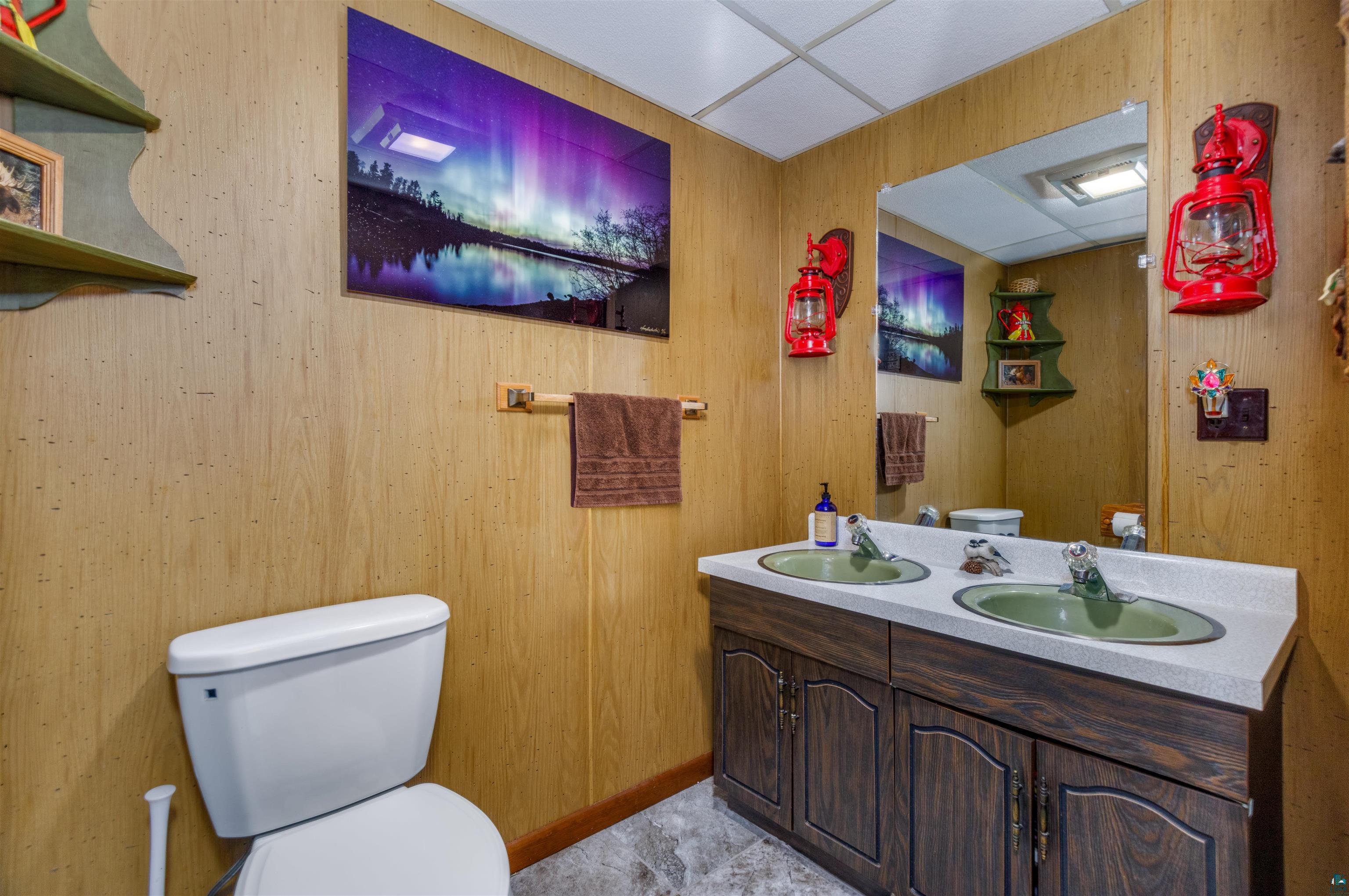 2641 Priest Point Road Ely, MN 55731 - Photo 29 of 38 Half bathroom with double vanity and a drop ceiling