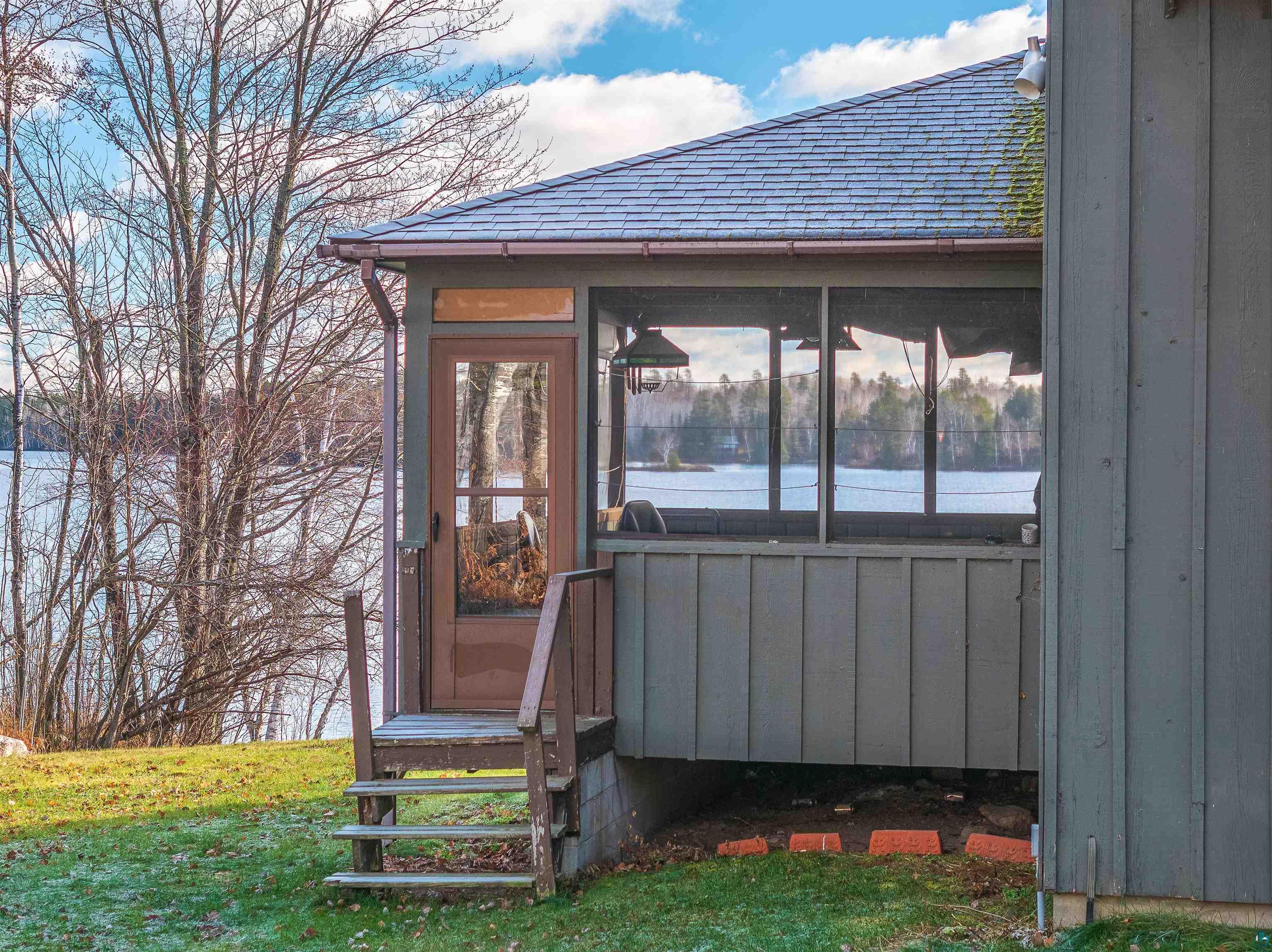 2641 Priest Point Road Ely, MN 55731 - Photo 6 of 38 Entrance to property featuring a sunroom and roof with shingles