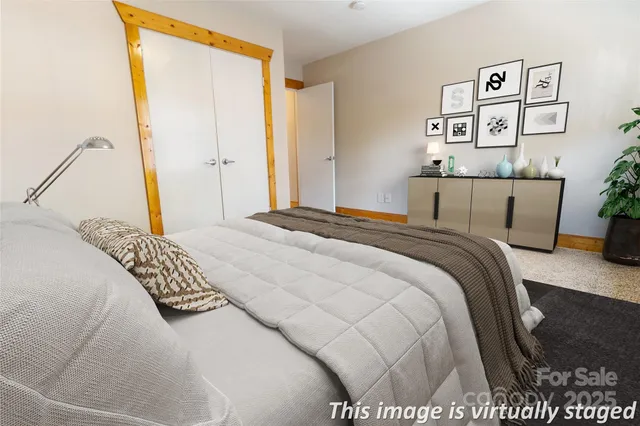 a bedroom with a bed and painting on the wall