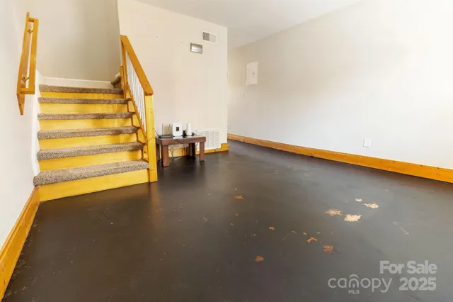 a view of an empty room with windows