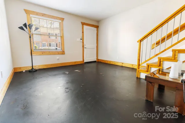 a view of hallway with wooden floor