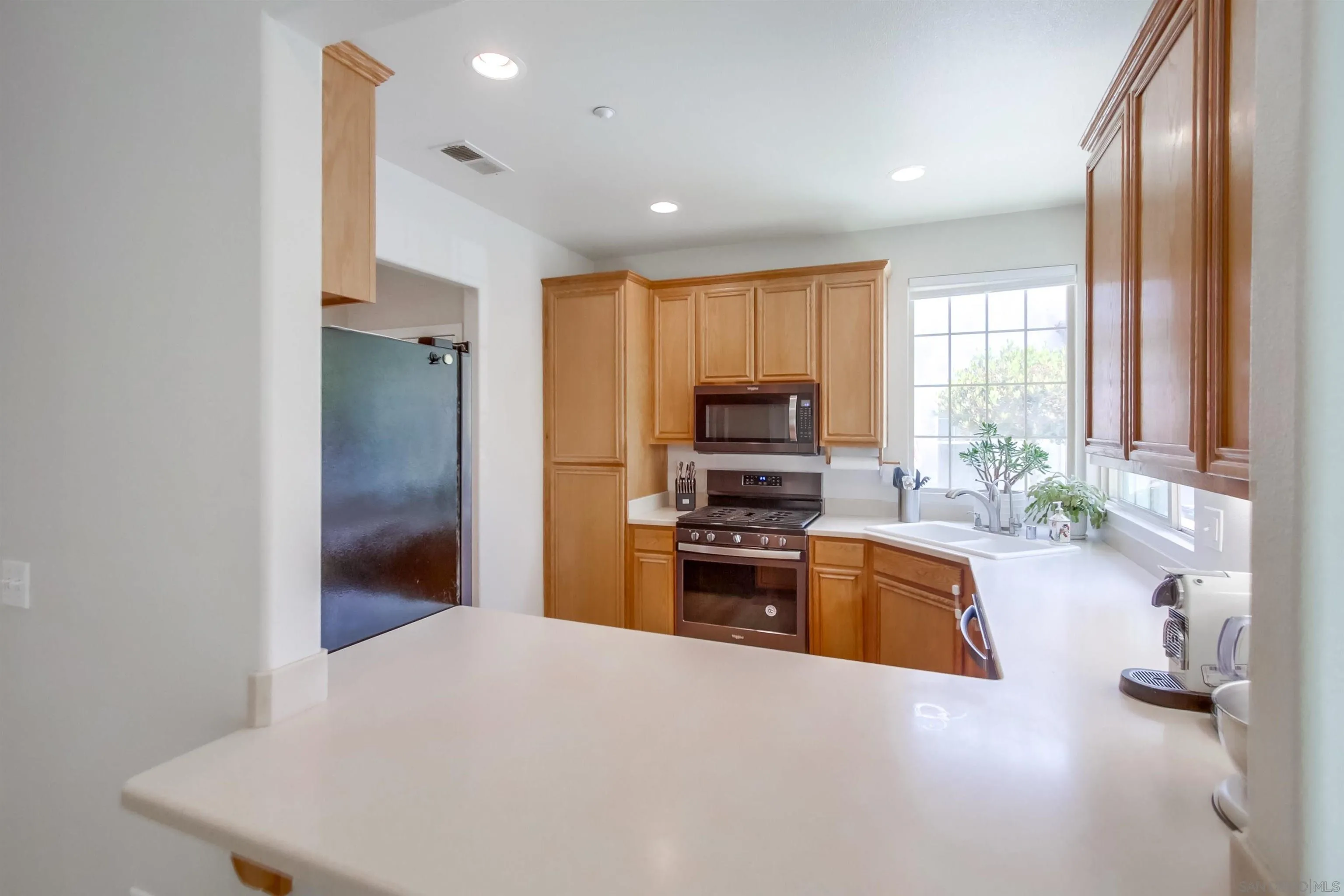 8535 Elliot Lane Santee, CA 92071 - Photo 15 of 43 a kitchen with stainless steel appliances a refrigerator sink and stove