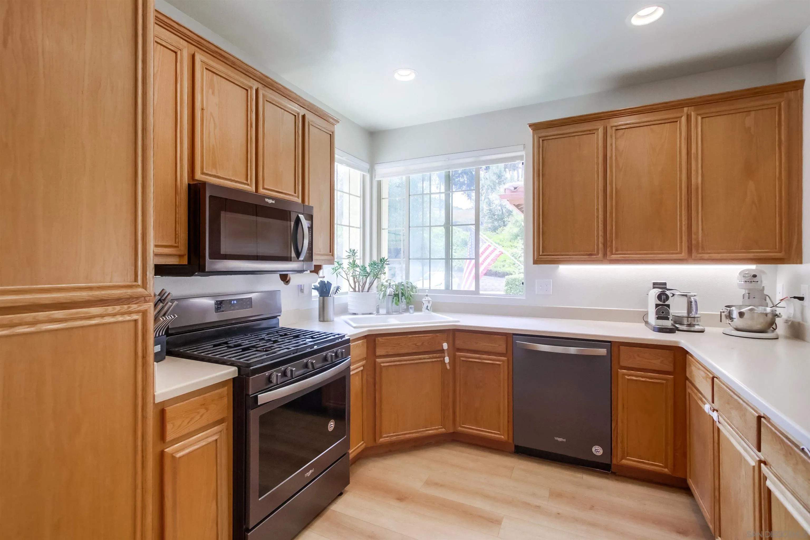 8535 Elliot Lane Santee, CA 92071 - Photo 16 of 43 a kitchen with stainless steel appliances a stove sink microwave and refrigerator