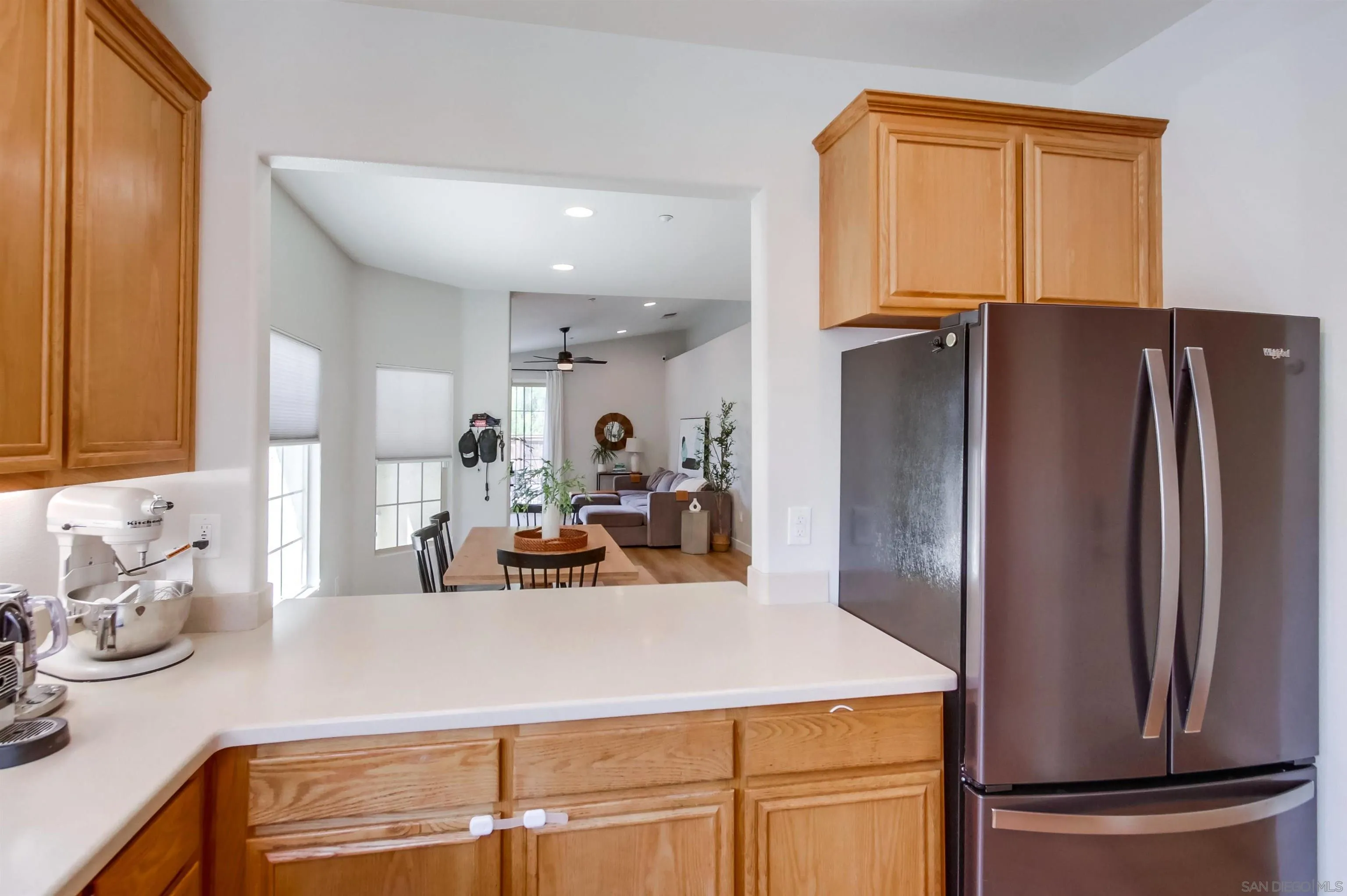 8535 Elliot Lane Santee, CA 92071 - Photo 18 of 43 a view of a kitchen with kitchen island a refrigerator a sink and a stove top oven