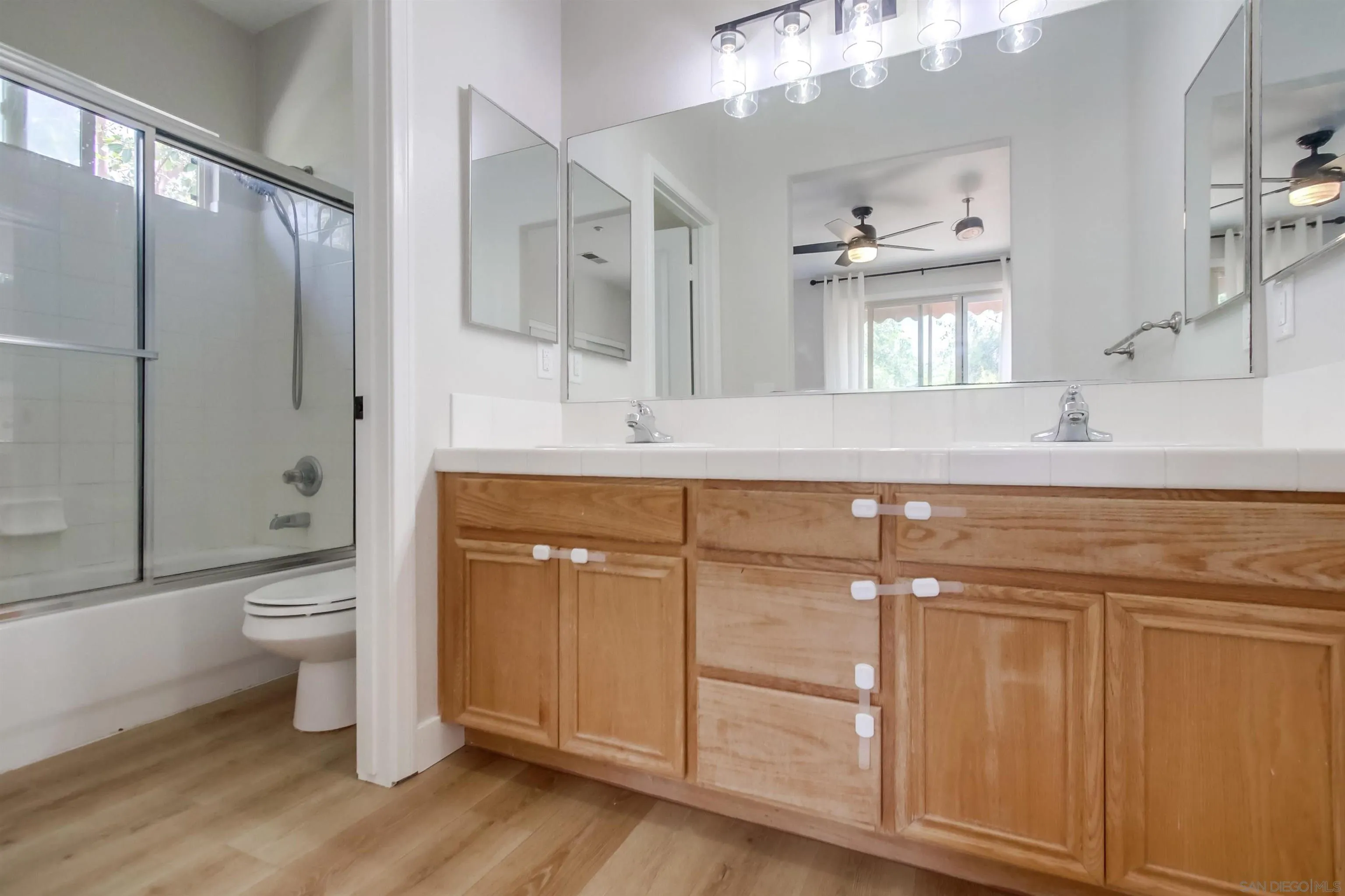 8535 Elliot Lane Santee, CA 92071 - Photo 22 of 43 a bathroom with a granite countertop sink toilet and shower
