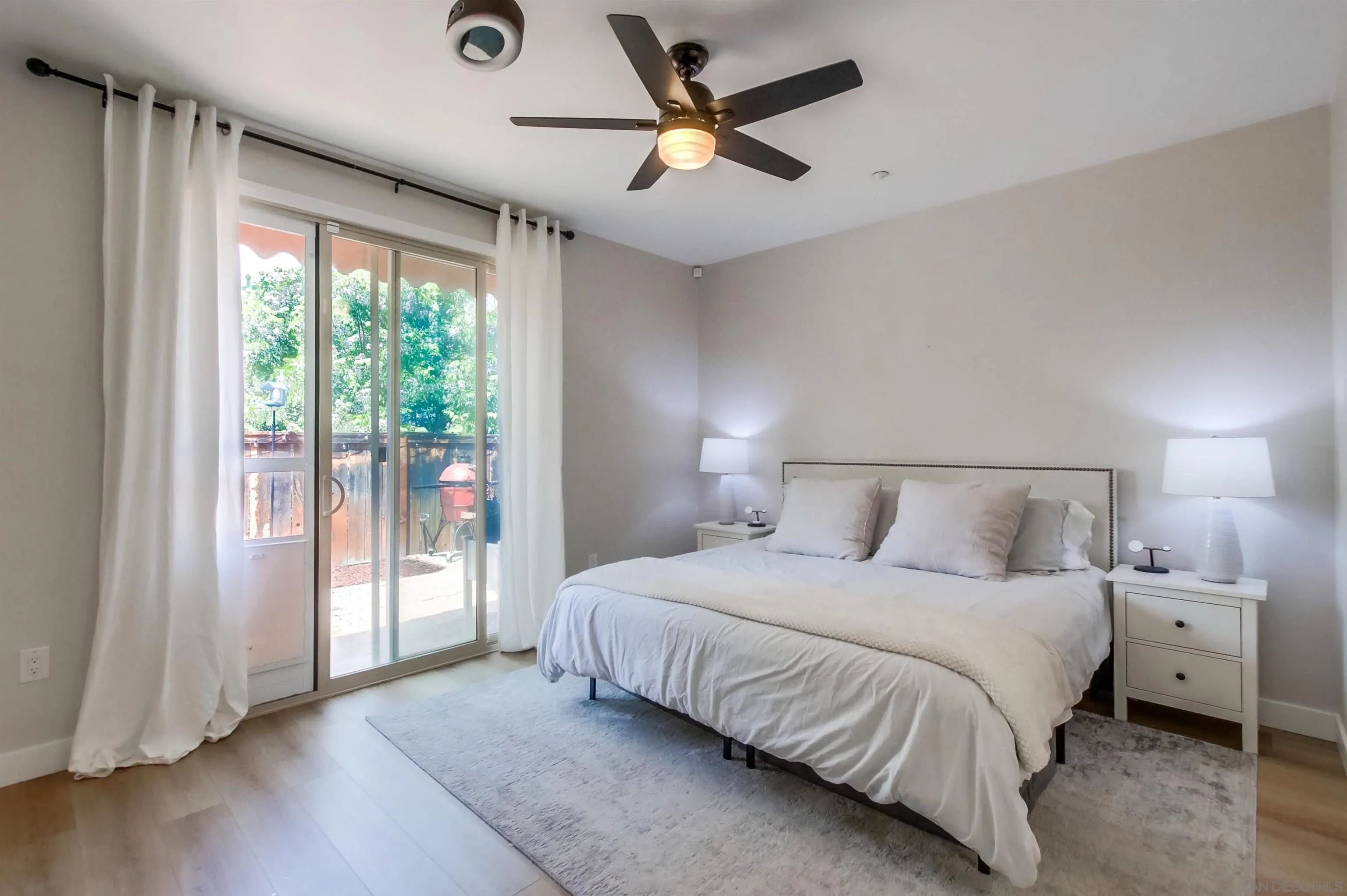 8535 Elliot Lane Santee, CA 92071 - Photo 6 of 43 a bedroom with a large bed and a chandelier fan