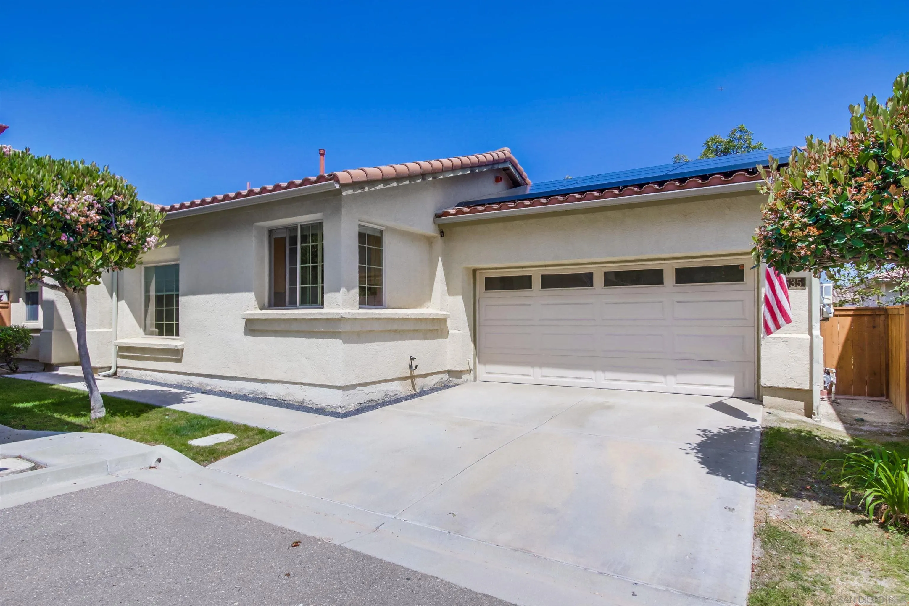 8535 Elliot Lane Santee, CA 92071 - Photo 9 of 43 a white house with a small yard and a large parking space