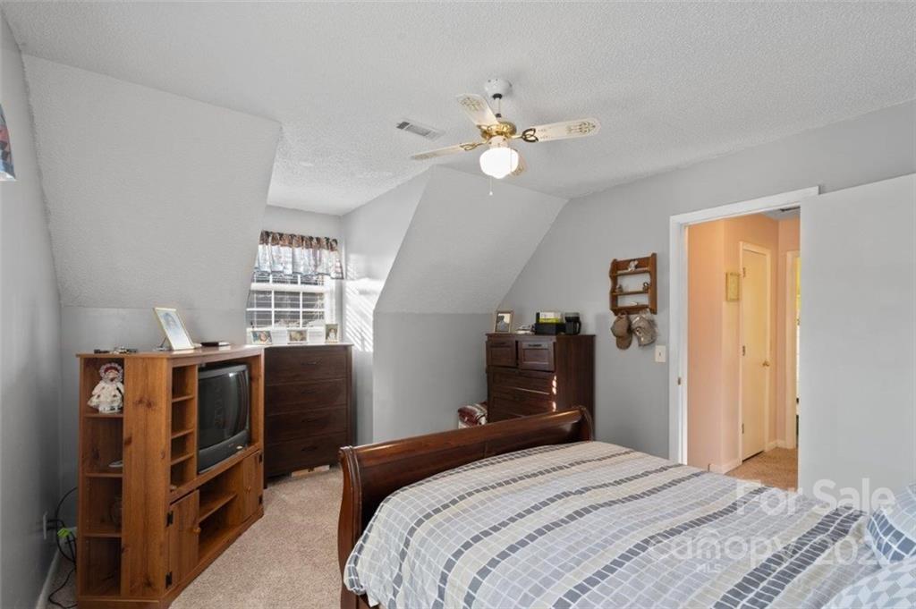 143 Mathis Dairy Road Spartanburg, SC 29307 - Photo 11 of 16 a bedroom with a bed and wooden floor