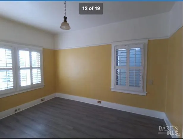 a kitchen with granite countertop stainless steel appliances a stove and wooden floor