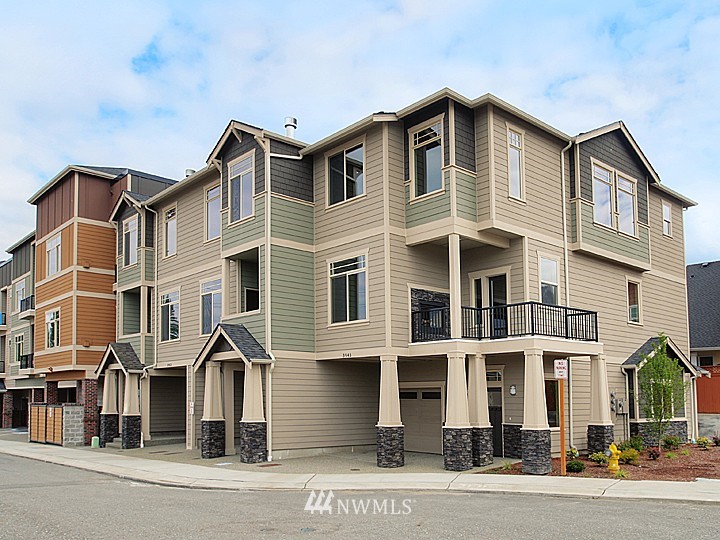 3910 Northeast 3rd Place Renton, WA 98056 - Photo 1 of 15 a front view of a residential apartment building with a yard