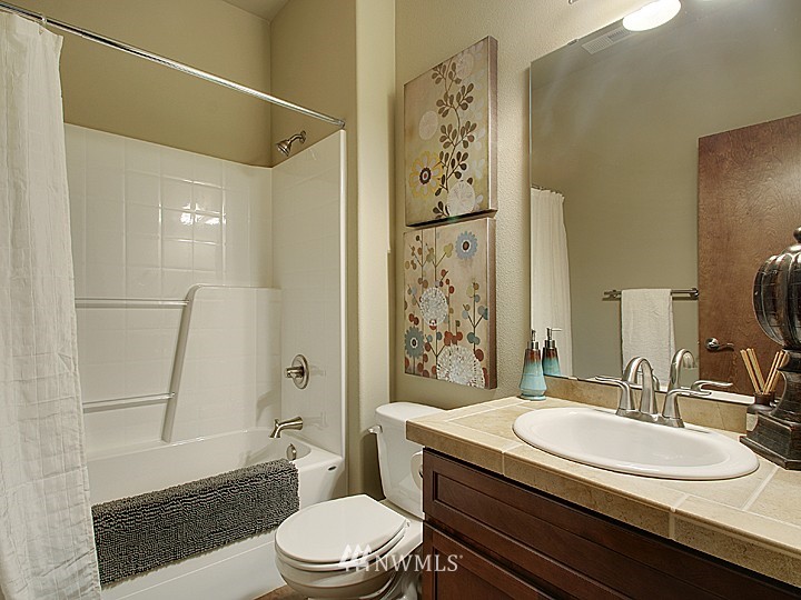 3910 Northeast 3rd Place Renton, WA 98056 - Photo 11 of 15 a bathroom with a granite countertop sink toilet and shower