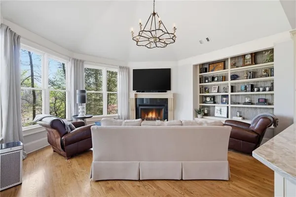 a spacious bedroom with a bed and a chandelier