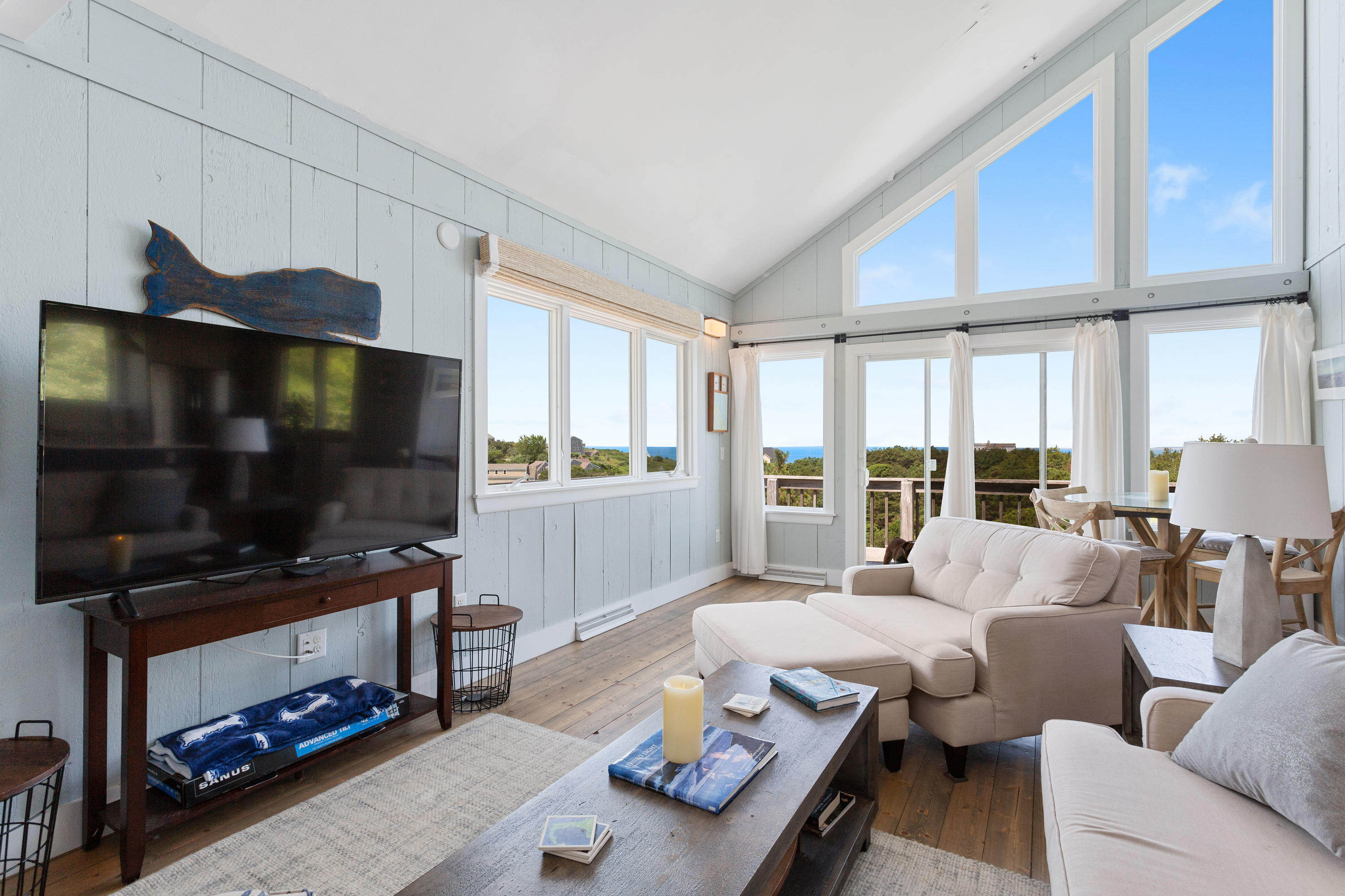 5 High Ridge Road Truro, MA 02666 - Photo 12 of 45 a living room with furniture a flat screen tv and a window