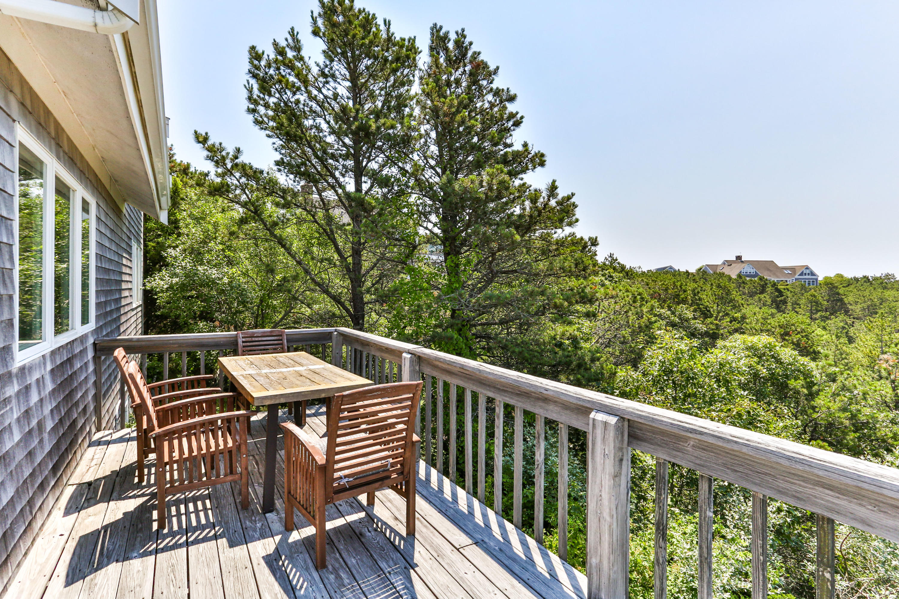 5 High Ridge Road Truro, MA 02666 - Photo 14 of 45 a view of a balcony with wooden floor and outdoor seating