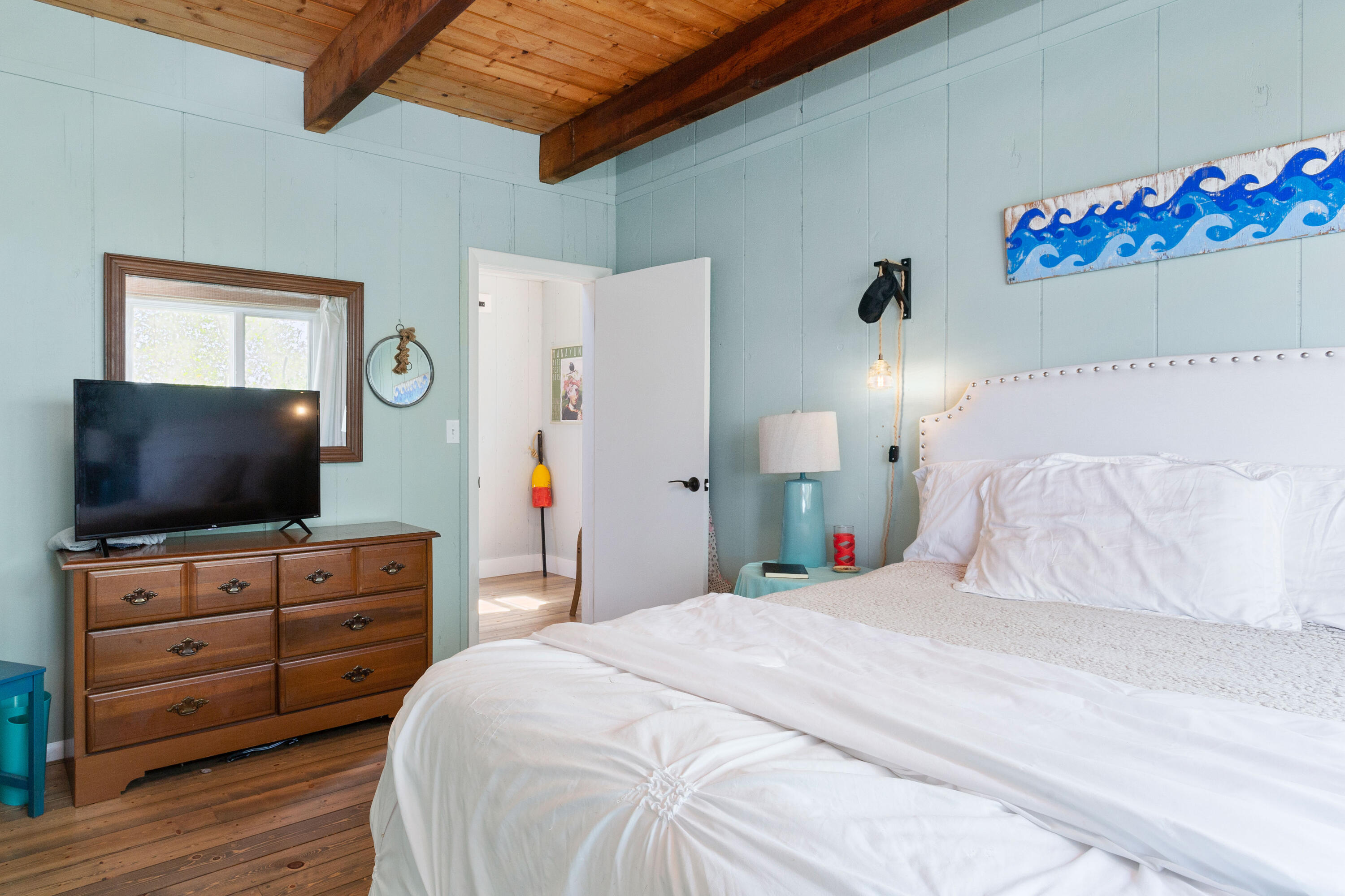 5 High Ridge Road Truro, MA 02666 - Photo 17 of 45 a bedroom with a bed and a flat screen tv
