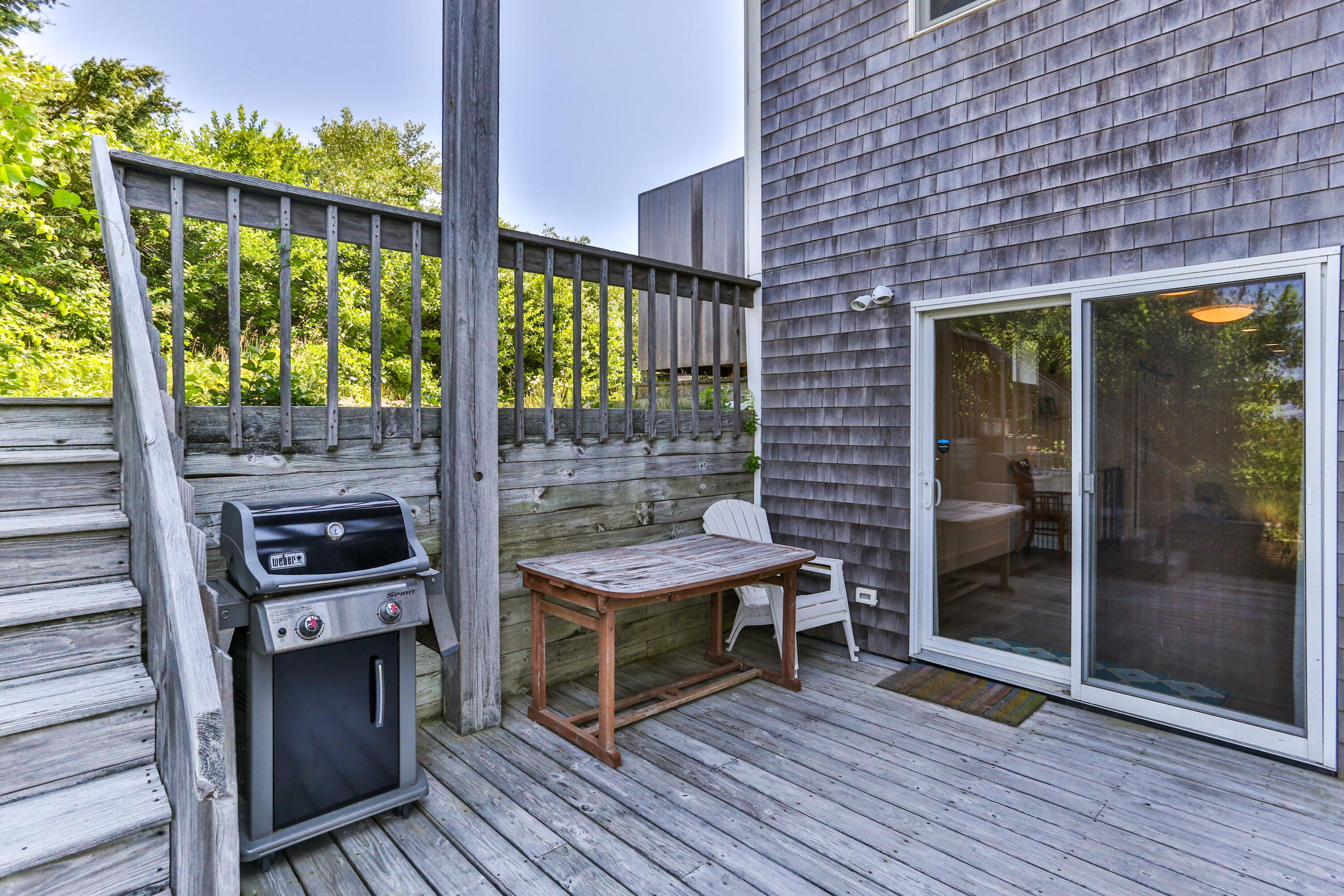 5 High Ridge Road Truro, MA 02666 - Photo 36 of 45 a backyard of a house with barbeque oven table and chairs