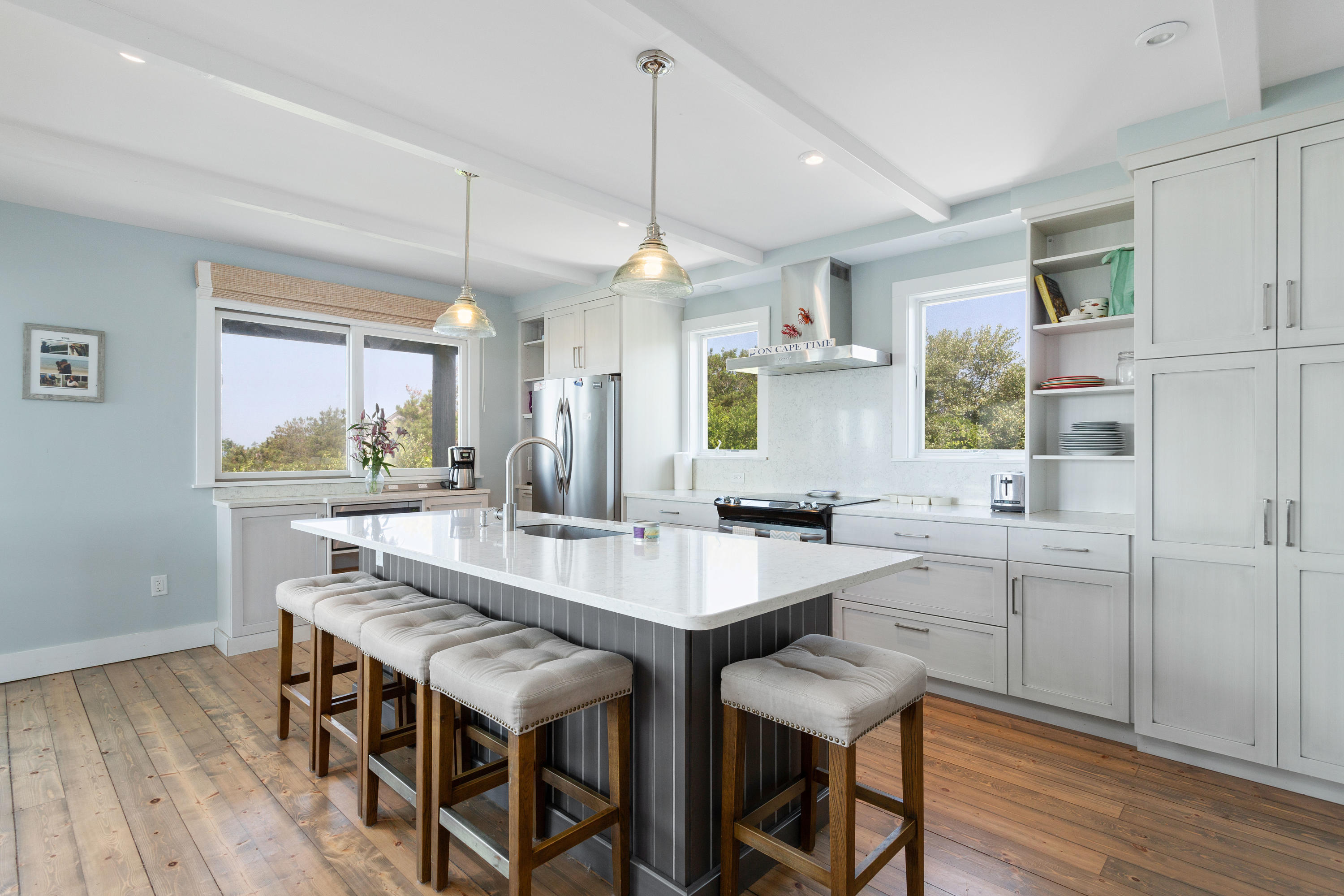 5 High Ridge Road Truro, MA 02666 - Photo 4 of 45 a kitchen with a dining table chairs cabinets wooden floor and appliances