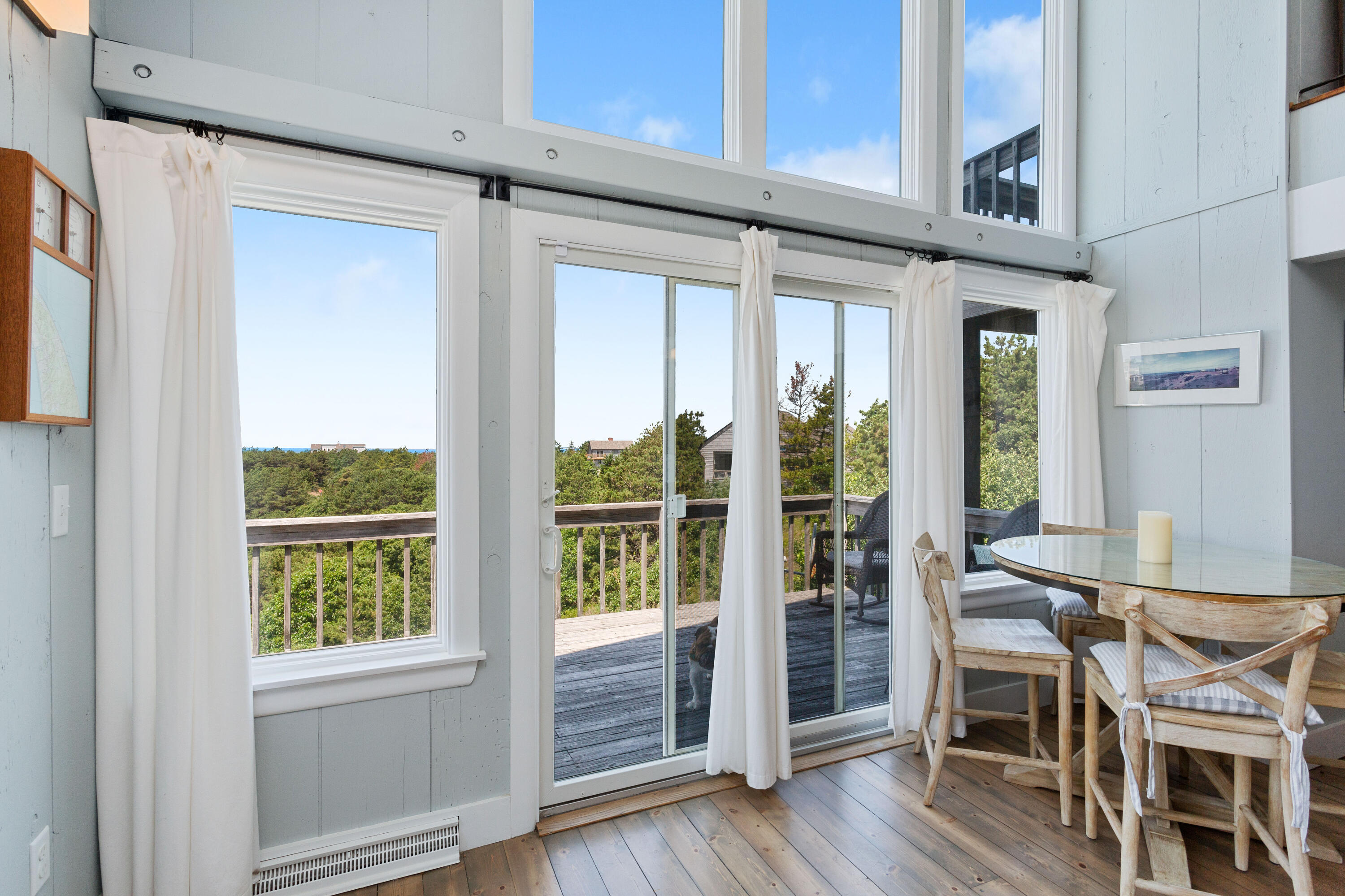 5 High Ridge Road Truro, MA 02666 - Photo 9 of 45 a dining room with wooden floor and windows