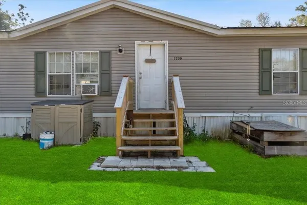 a car parked in front of a house with a small yard