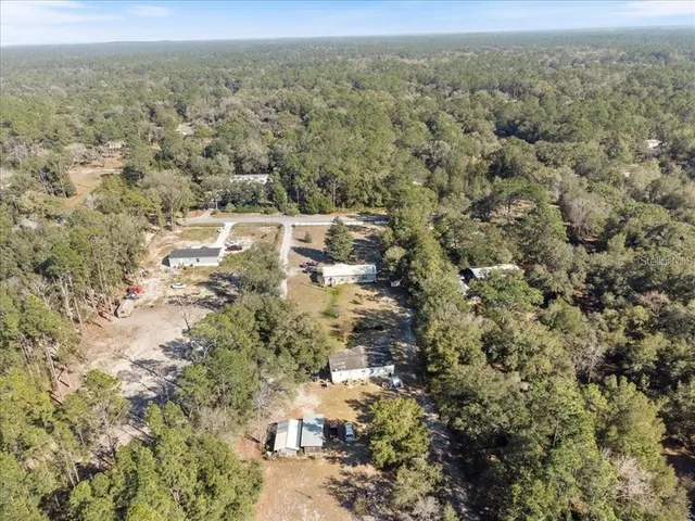 a aerial view of a house with a yard patio and sitting area