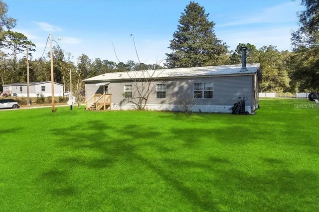 a view of a house with a yard and a garage