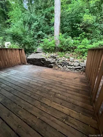 a view of a street with wooden fence