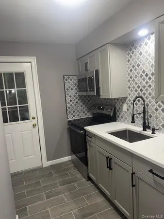 a kitchen with a sink and cabinets