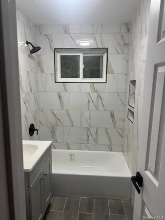 a bathroom with a sink a bathtub and a shower