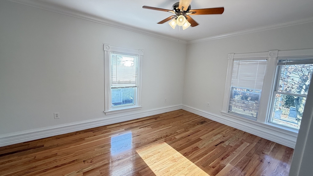 174 Boston Street, Unit 3 Boston, MA 02125 - Photo 11 of 13 a view of an empty room with wooden floor and a window