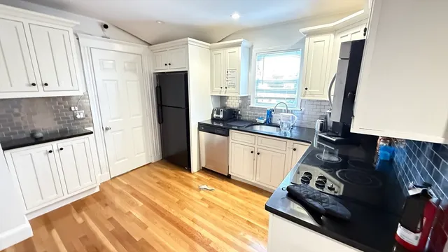 a kitchen with a sink stove and refrigerator
