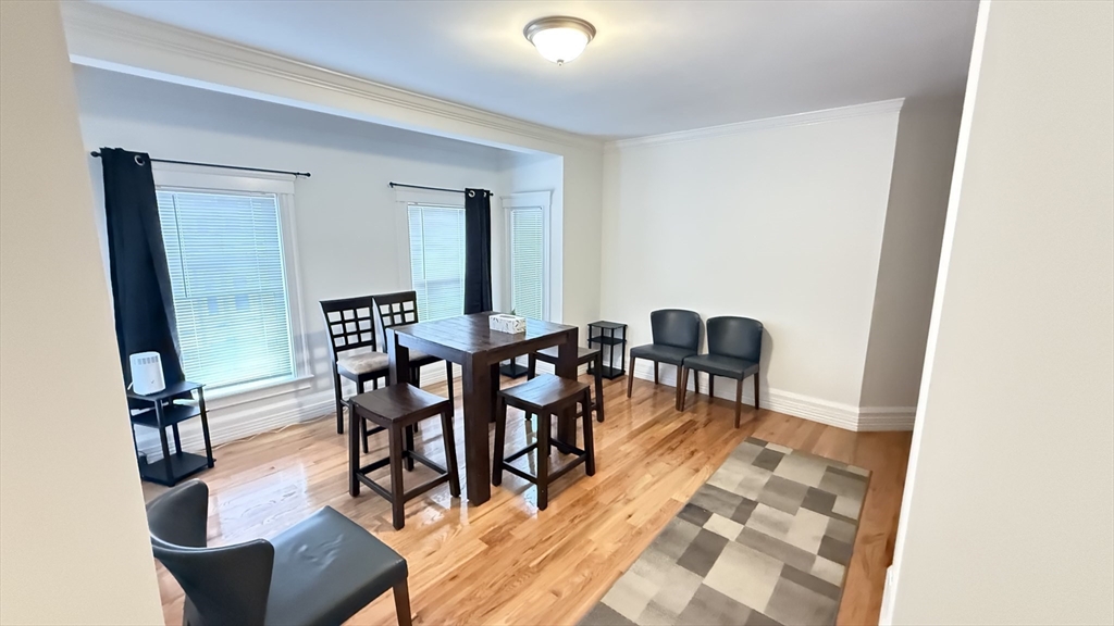 174 Boston Street, Unit 3 Boston, MA 02125 - Photo 3 of 13 a view of a dining room with furniture and wooden floor