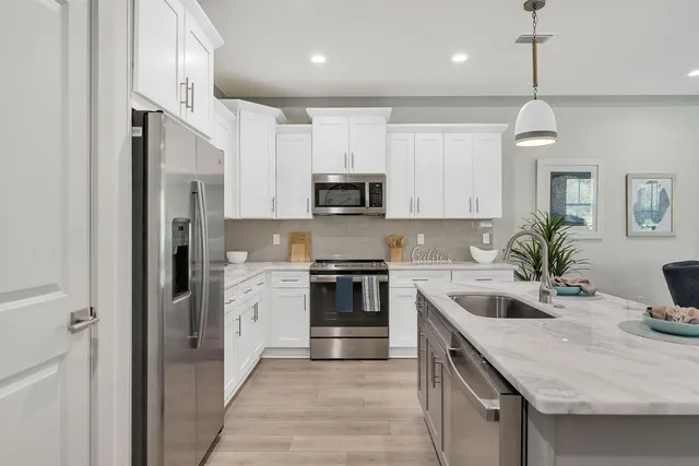 a kitchen with a sink stove and refrigerator