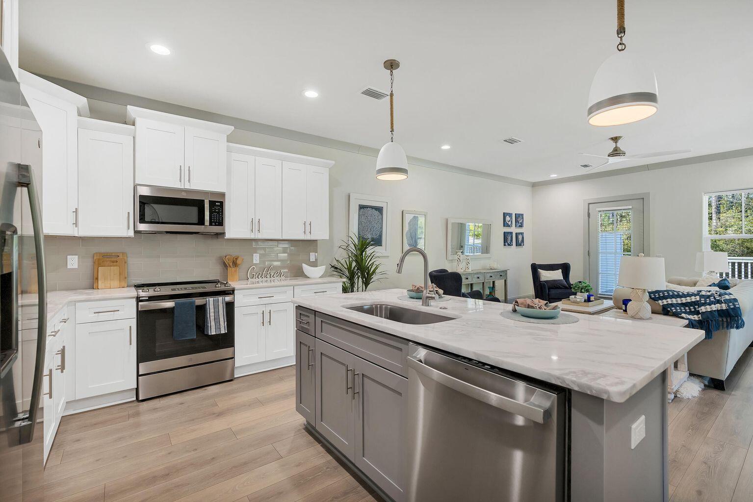 75 Golden Bell Ct Inlet Beach, Unit D Inlet Beach, FL 32461 - Photo 10 of 32 a kitchen with a sink and a stove top oven with wooden floor