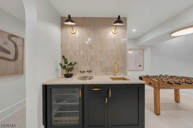 a bathroom with a granite countertop sink a toilet and a mirror