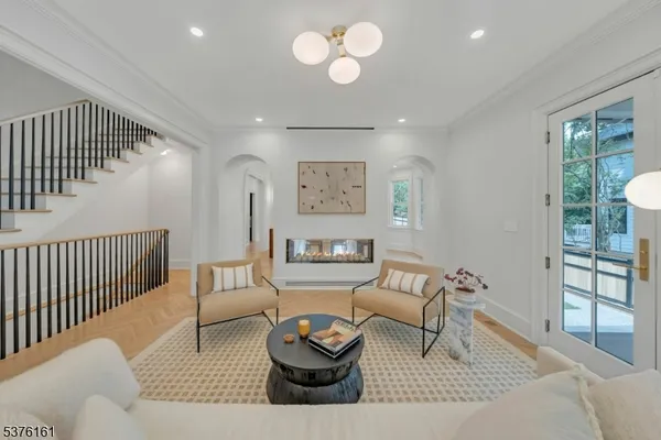 a living room with furniture and a chandelier
